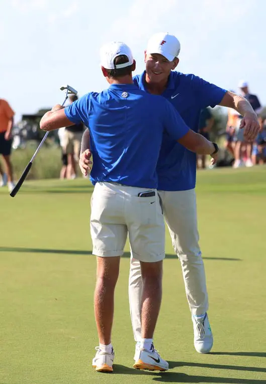 Two golfers hugging